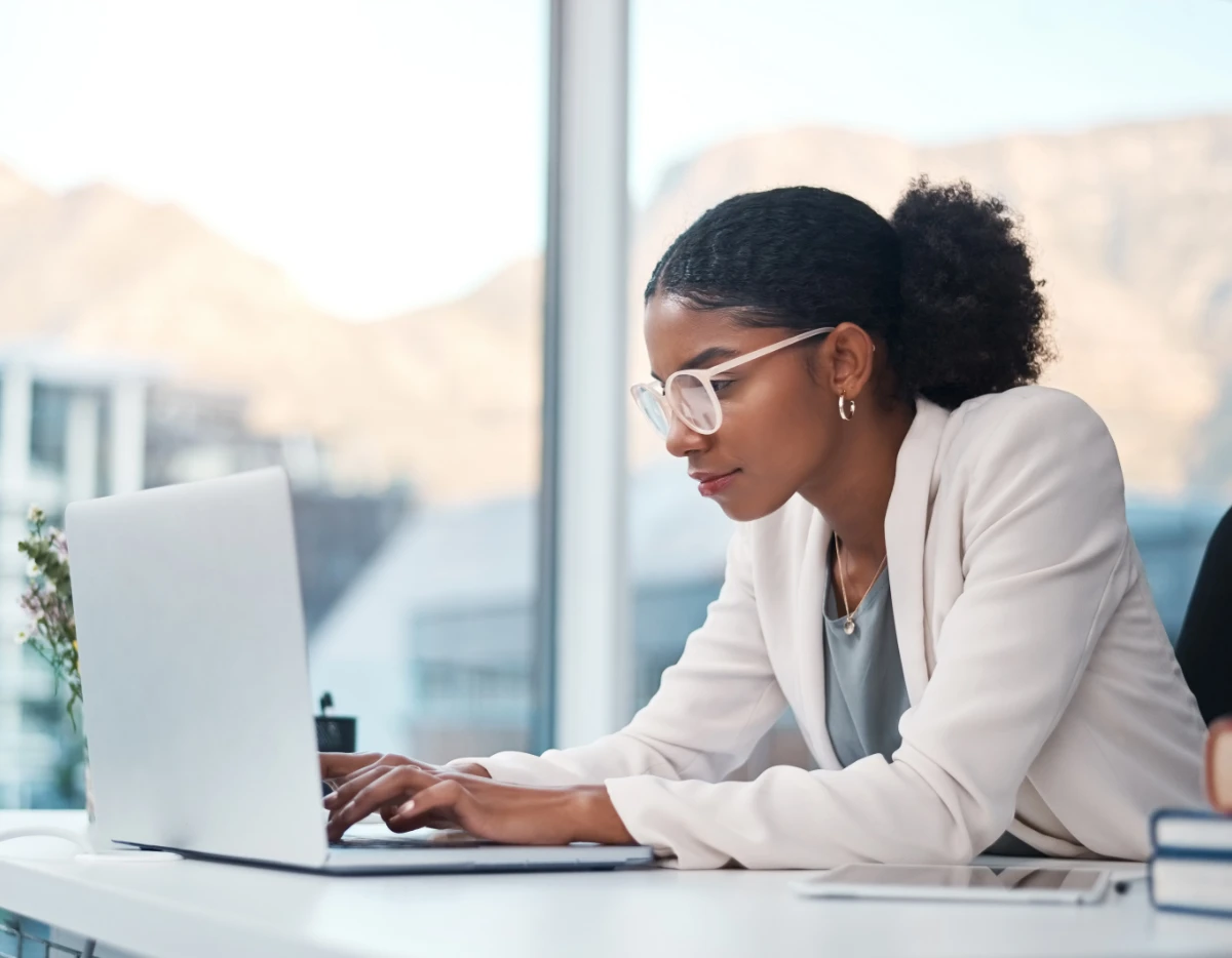 Professional woman working on laptop in office